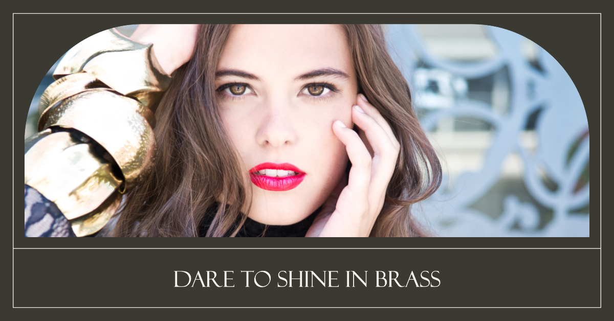 Person with obscured face wearing brass bracelets, hair detail, “DARE TO SHINE IN BRASS” text.