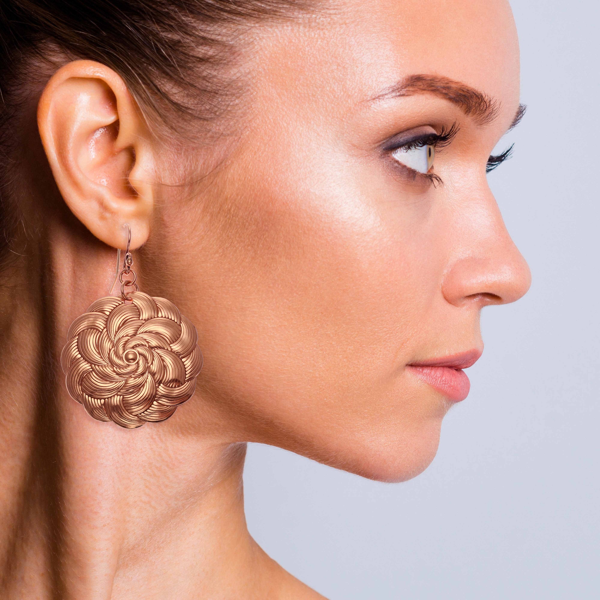 A Female Model Wearing Copper Mandala Disc Drop Earrings from John S. Brana