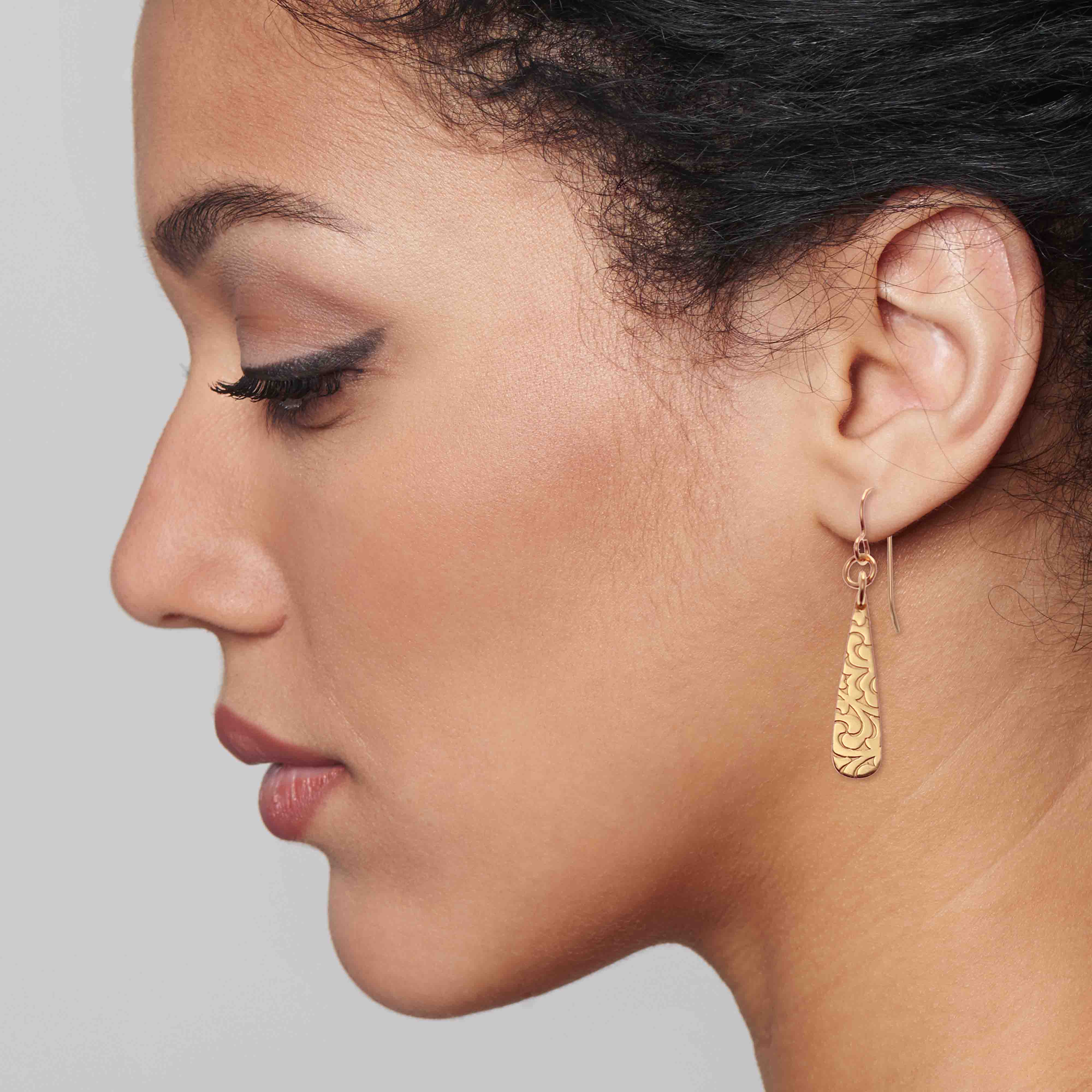 4 of 7: Elegant Woman Wearing Damask Embossed Mini Bronze Teardrop Earrings
