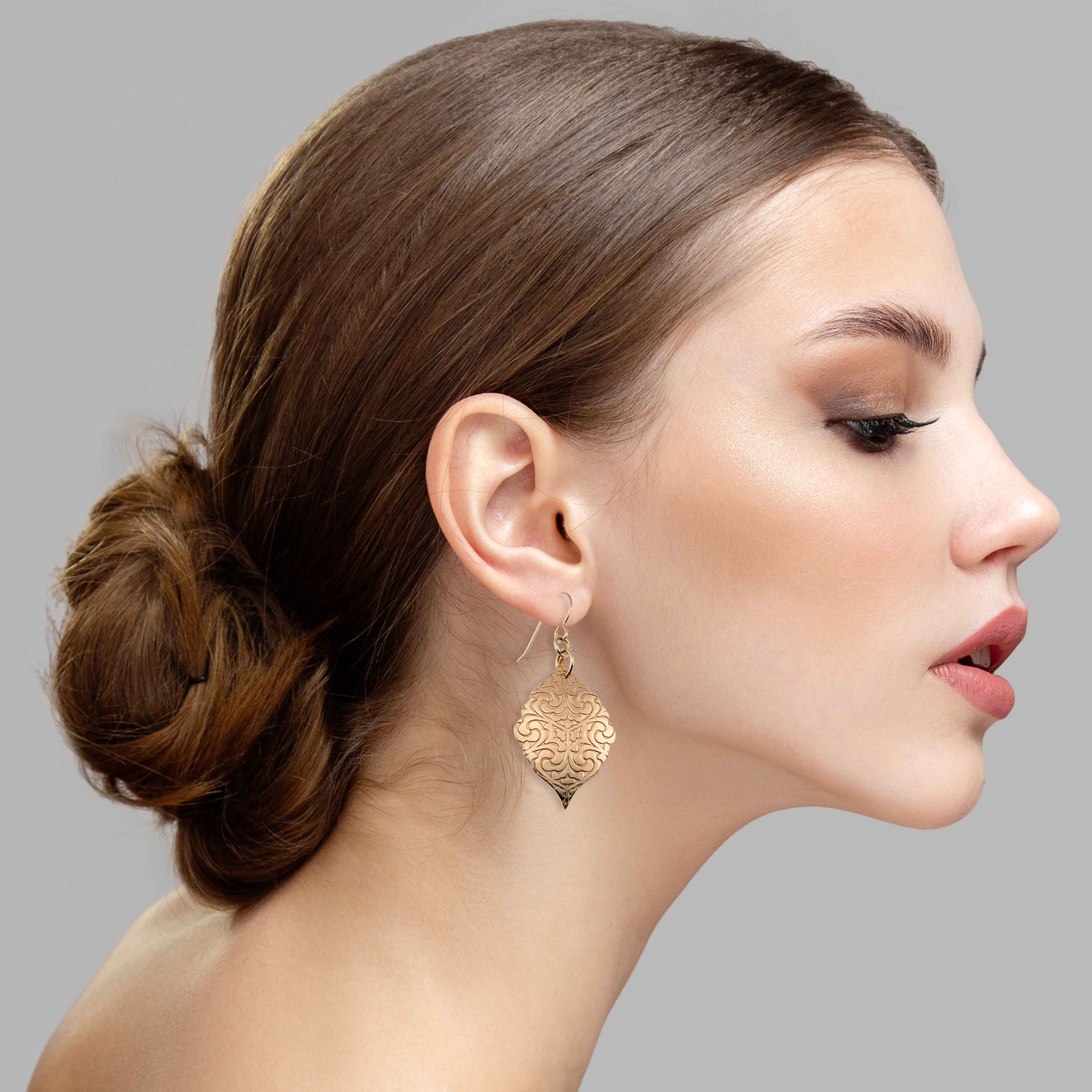 2 of 7: An Elegant Woman Wearing Damask Embossed Bronze Moroccan Drop Earrings