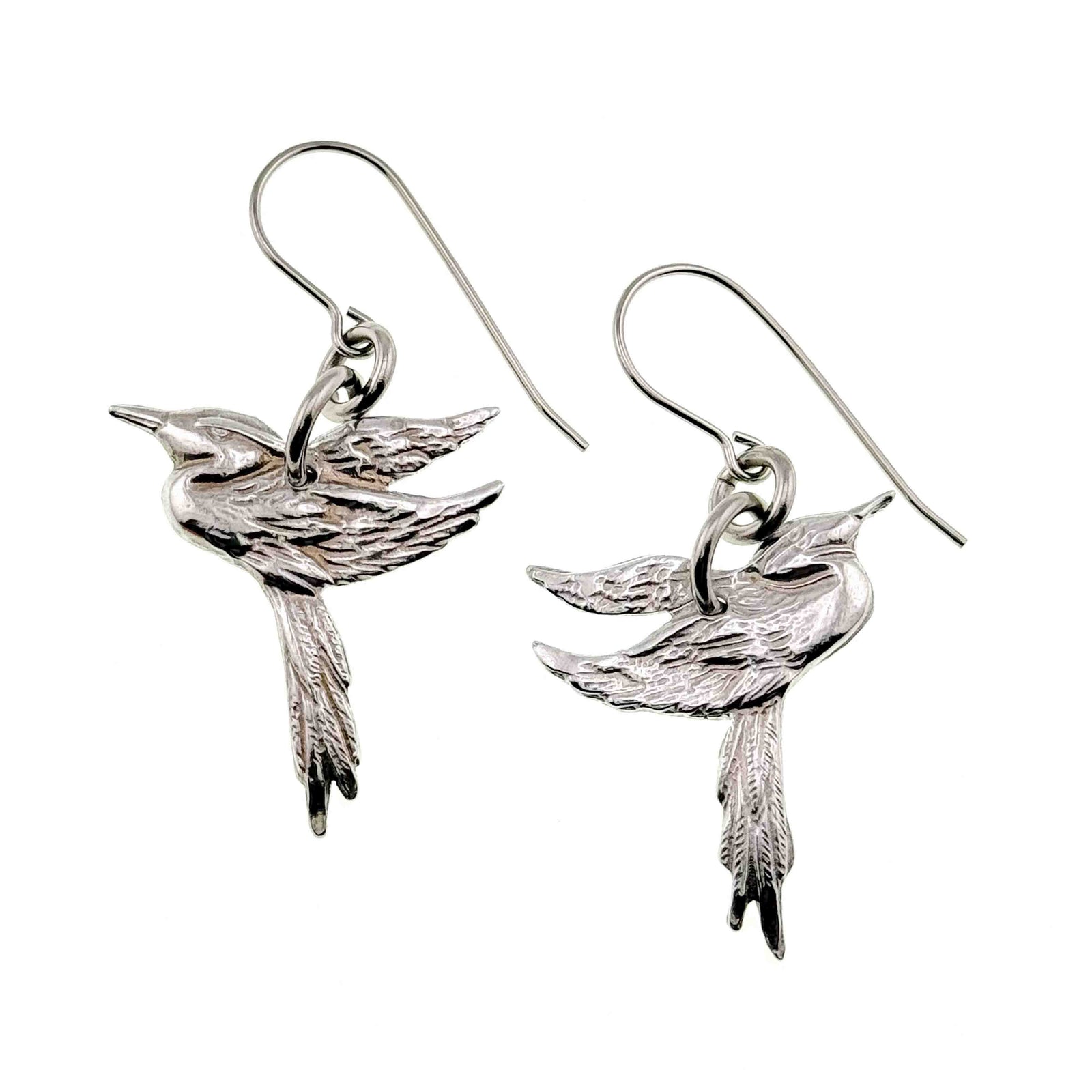 A Pair of Great Blue Heron Aluminum Earrings on a White Background