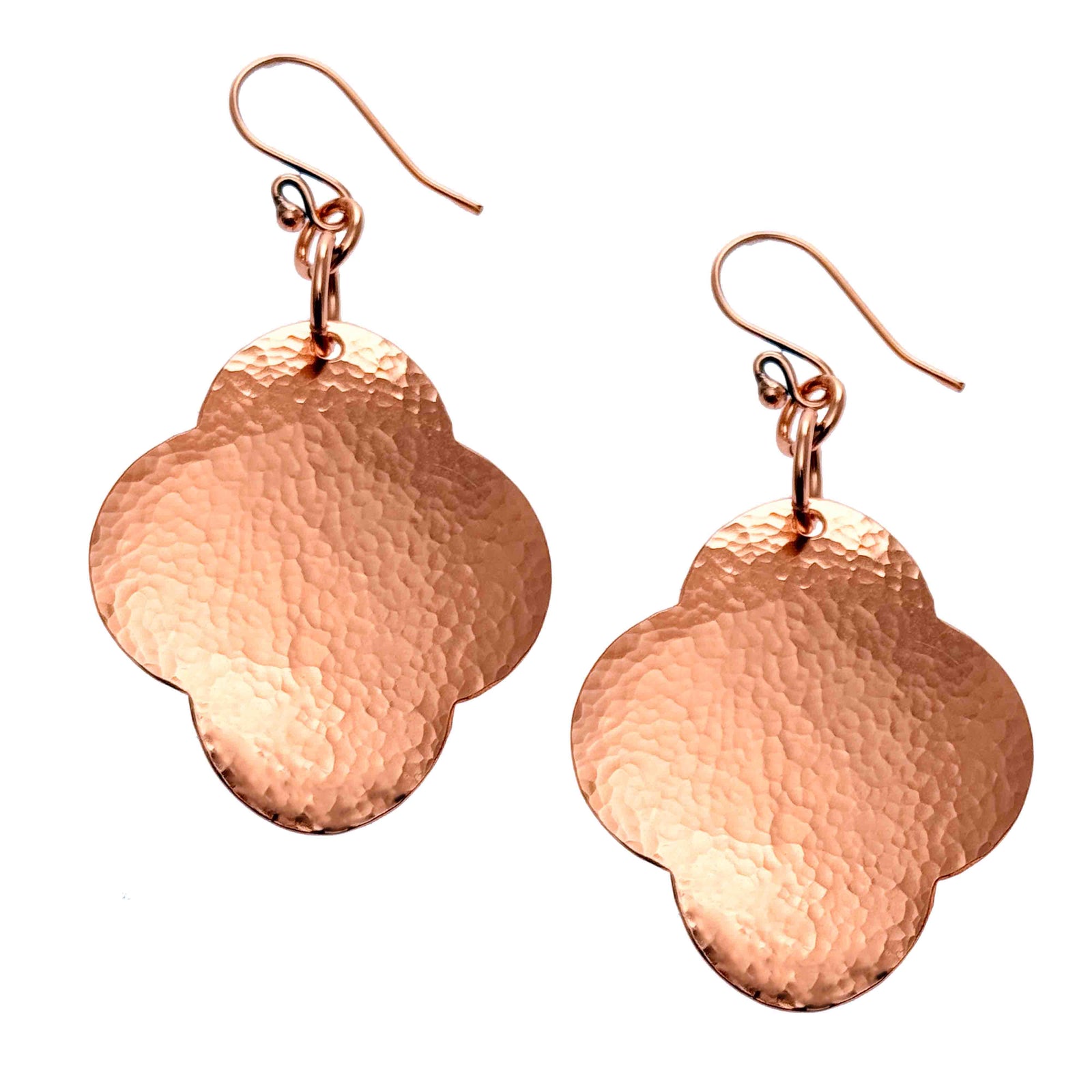 A Pair of Large Hammered Copper Clover Drop Earrings on a White Background