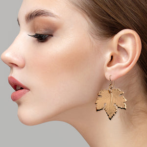 2 of 7: A Stunning Woman Wearing Large Maple Leaf Bronze Dangle Earrings