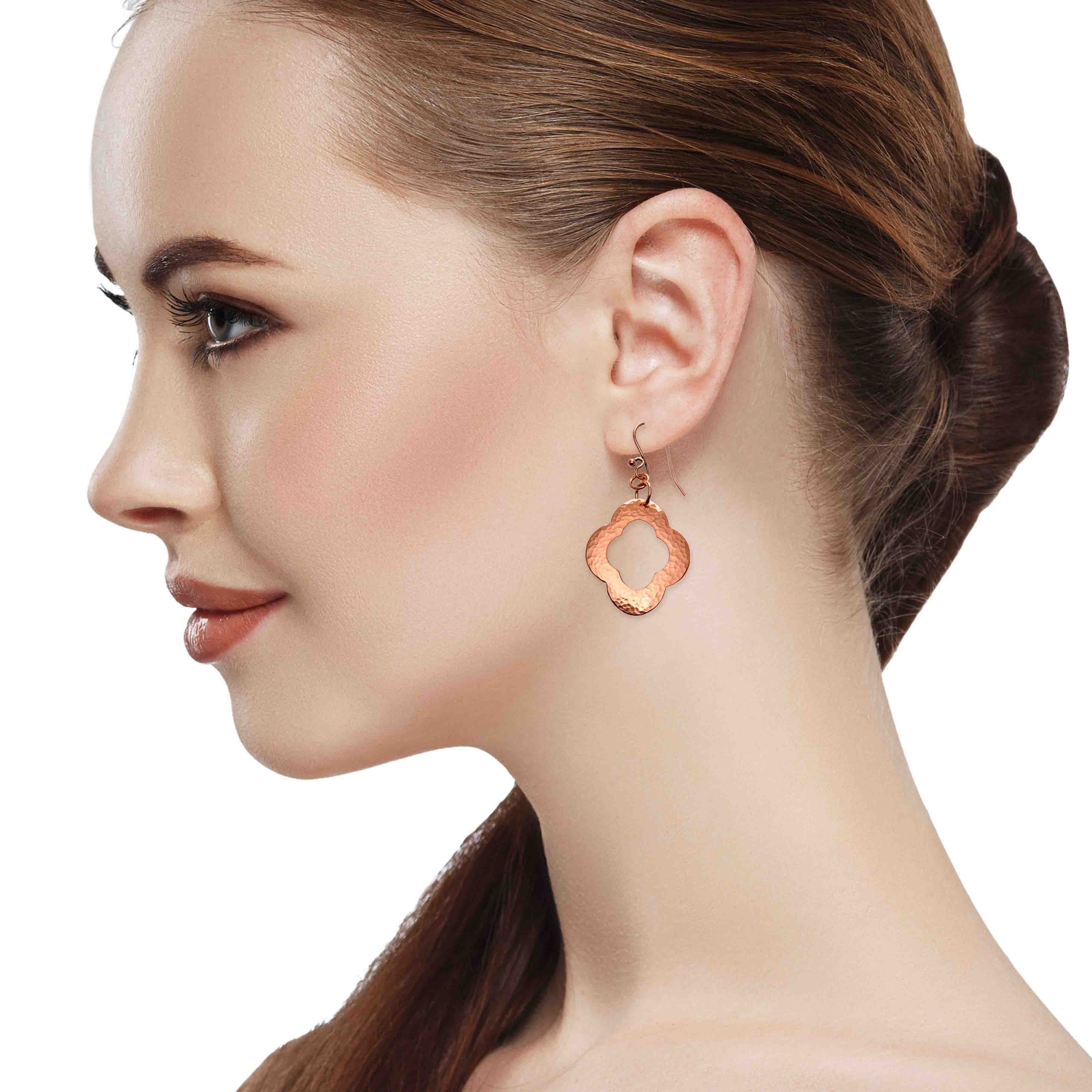 4 of 8: A Chic Woman Wearing Medium Pierced Copper Clover Drop Earrings