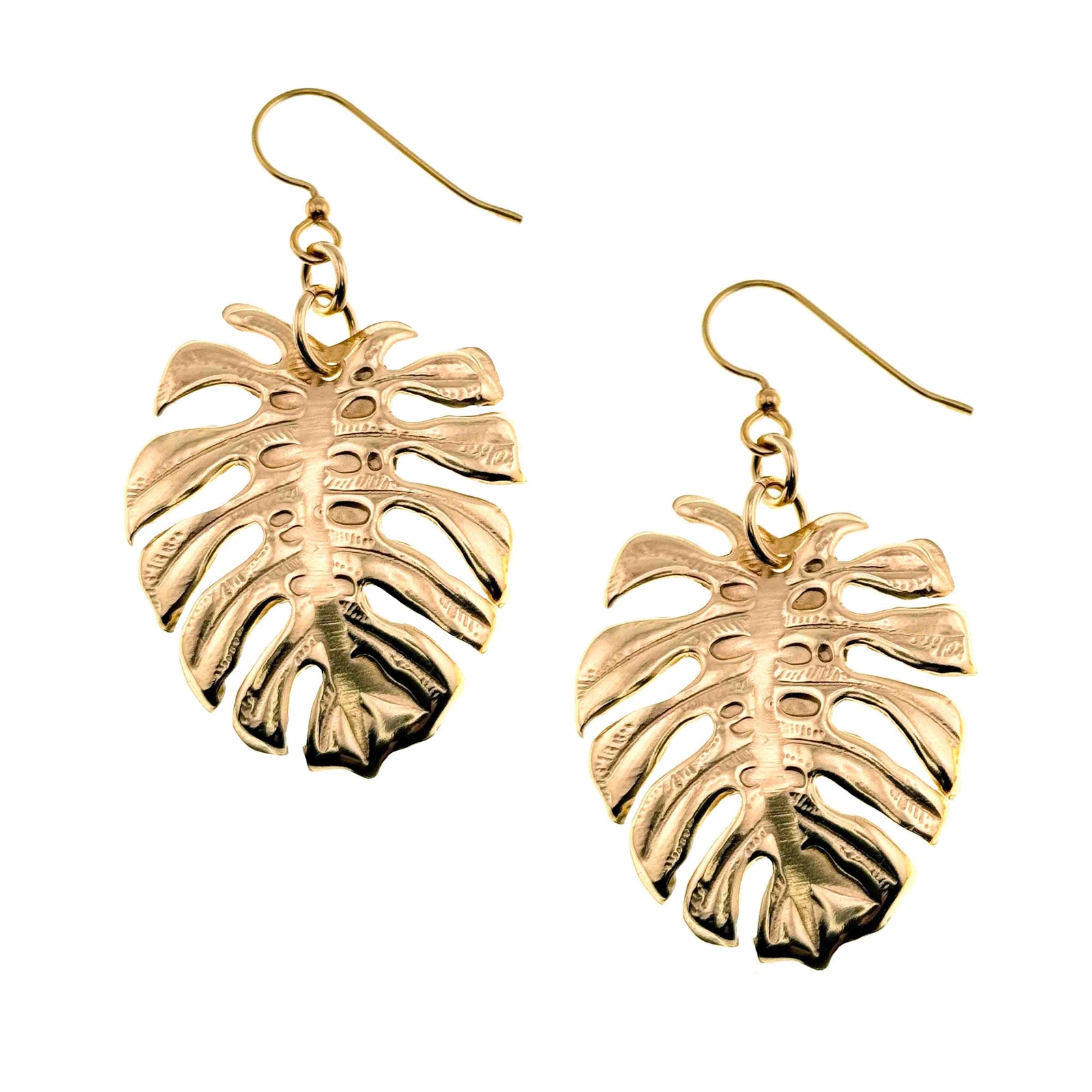 A Pair of Monstera Nu Gold Brass Leaf Earrings on a White Background