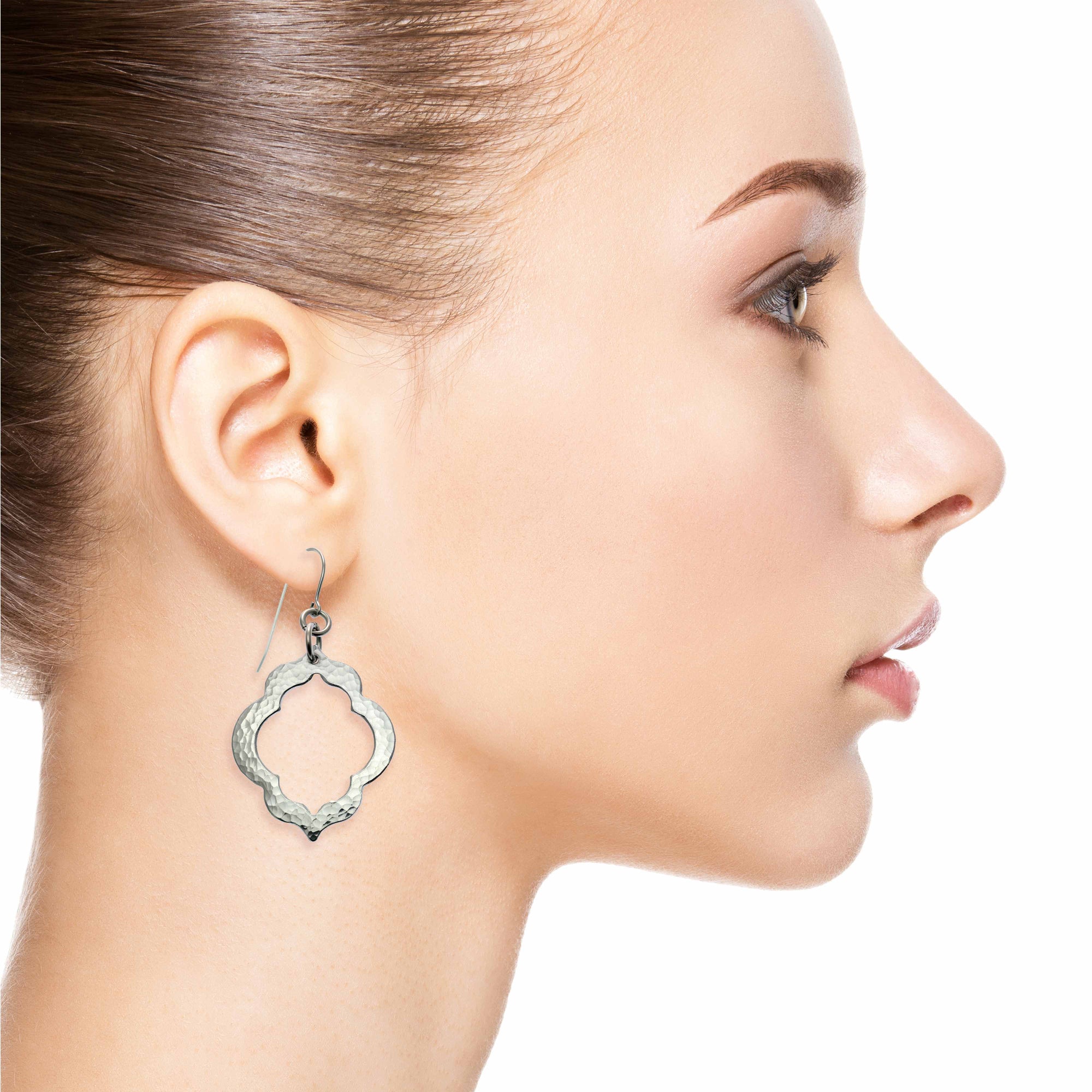 Side Profile of a Female Model Wearing Pierced Hammered Quatrefoil Aluminum Earrings