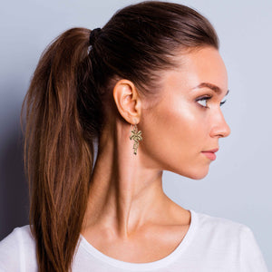6 of 7: Fashionable Woman Wearing Yuletide Ribbon Bronze Dangle Earrings