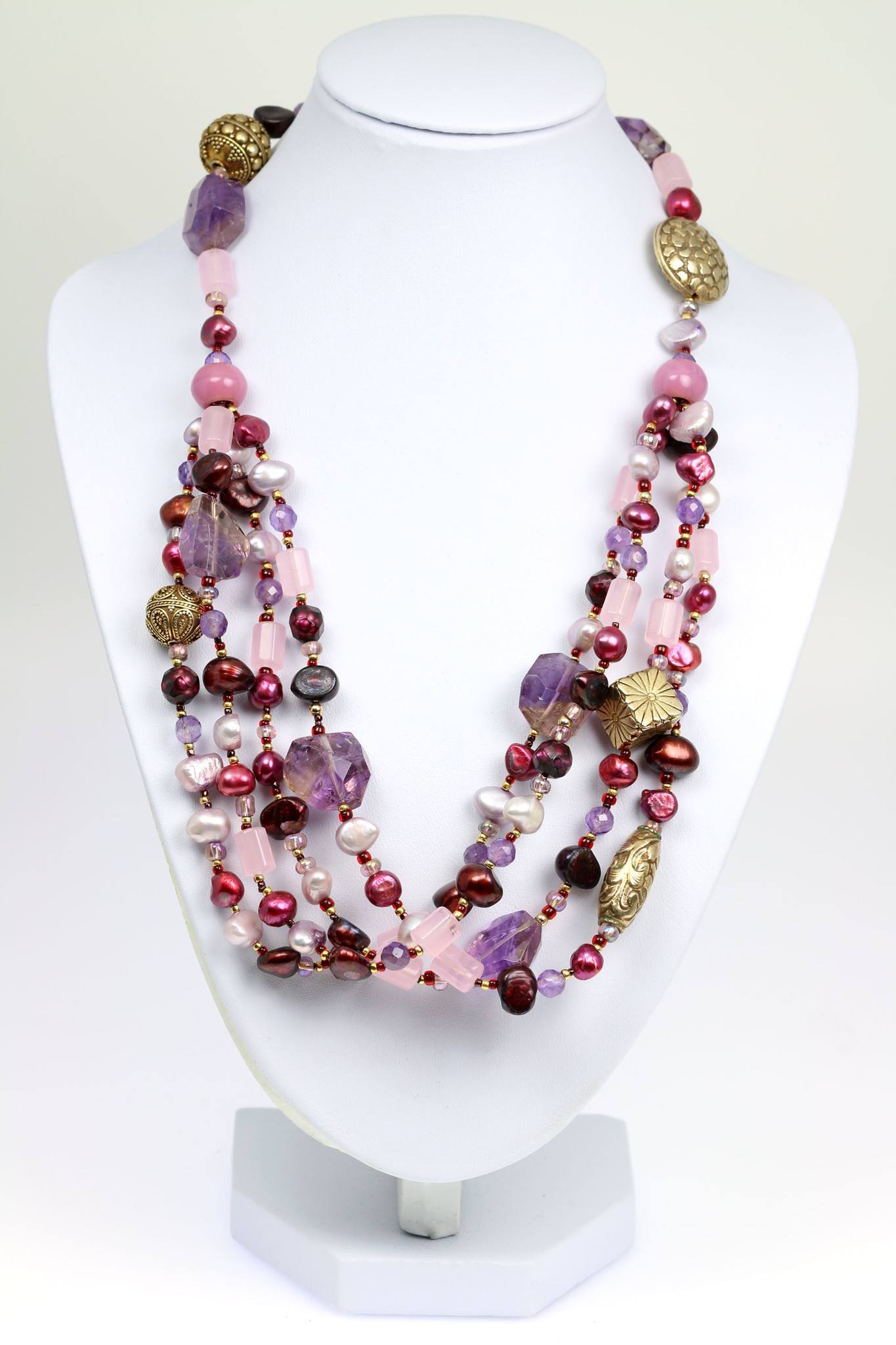 An Amethyst Rose Quartz Beaded Gemstone Necklace on a White Neck Display