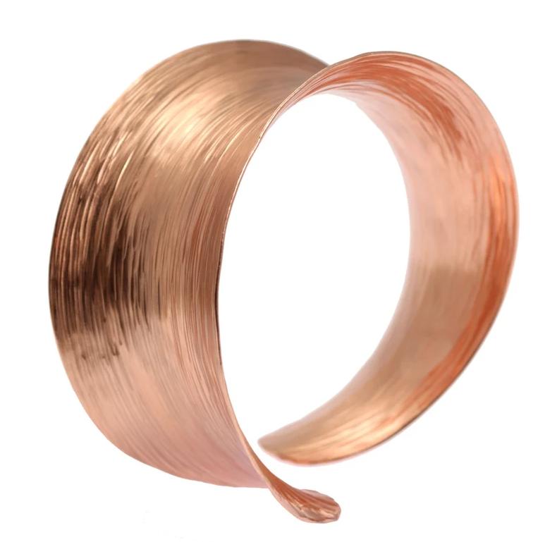 A Wide Anticlastic Copper Bark Bangle Bracelet on a White Background