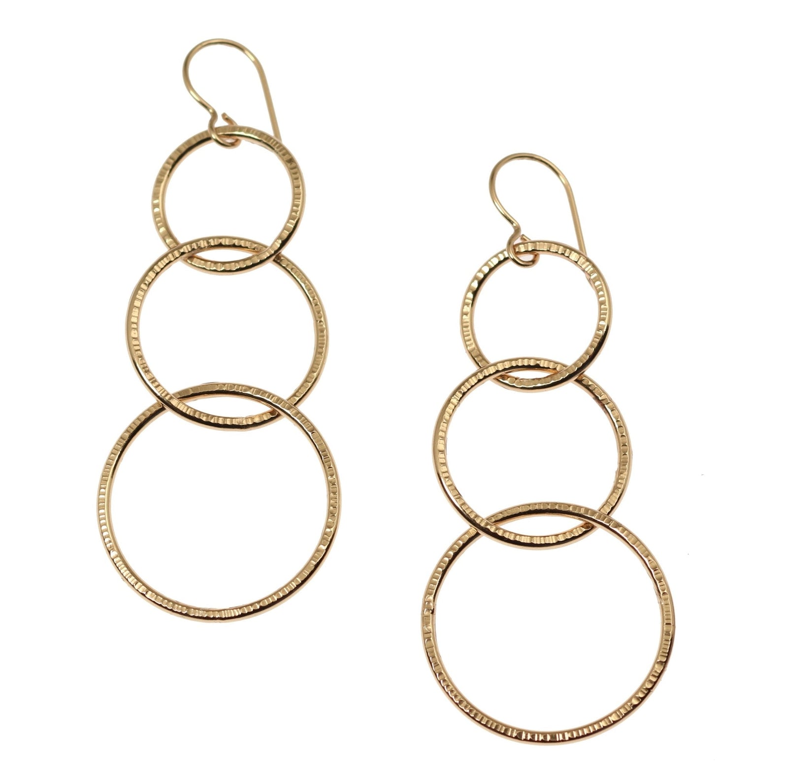 A Pair of Chased Bronze Three Tiered Dangle Earrings on a White Background