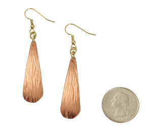 2 of 3: Size of Chased Copper Long Teardrop Earrings compared to a US Quarter Coin