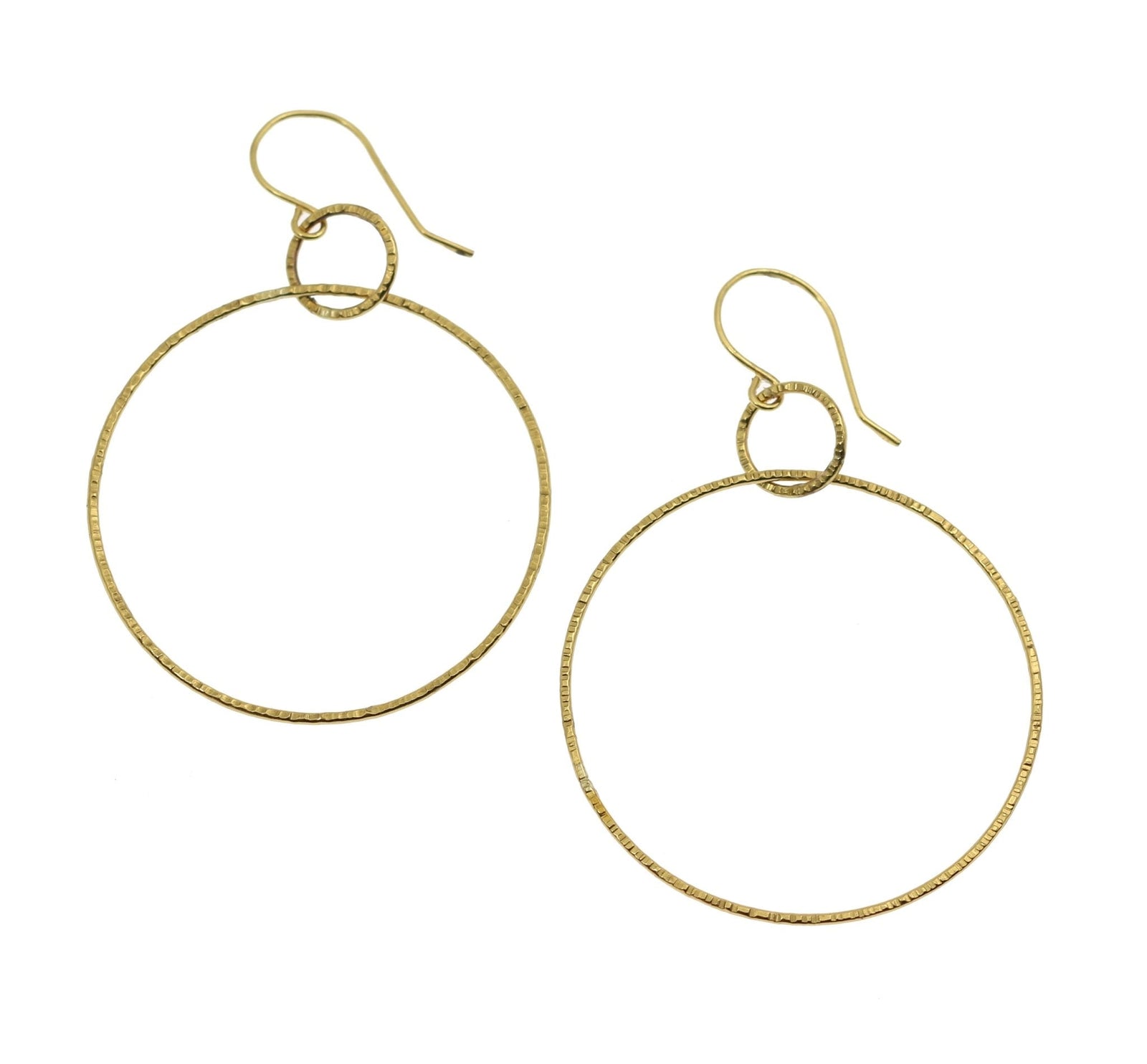 A Pair of Chased Nu Gold Brass Hoop Earrings on a White Background