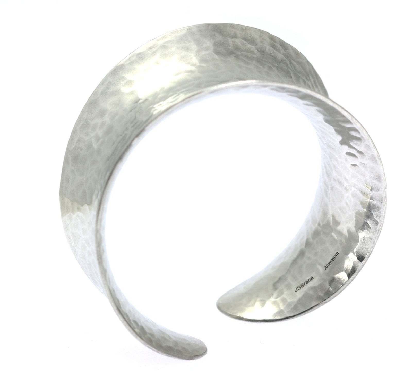 A Hammered Aluminum Anticlastic Bangle on a White Background