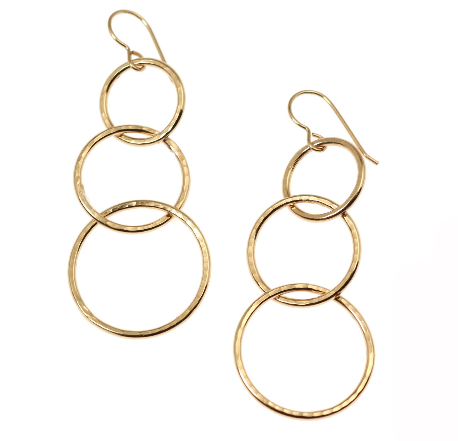 A Pair of Hammered Bronze Three Tiered Dangle Earrings on a White Background