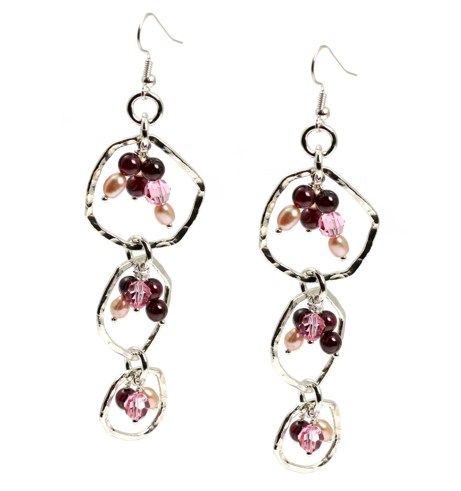 A Pair of Hammered Fine Silver Earrings with Garnets on a White Background