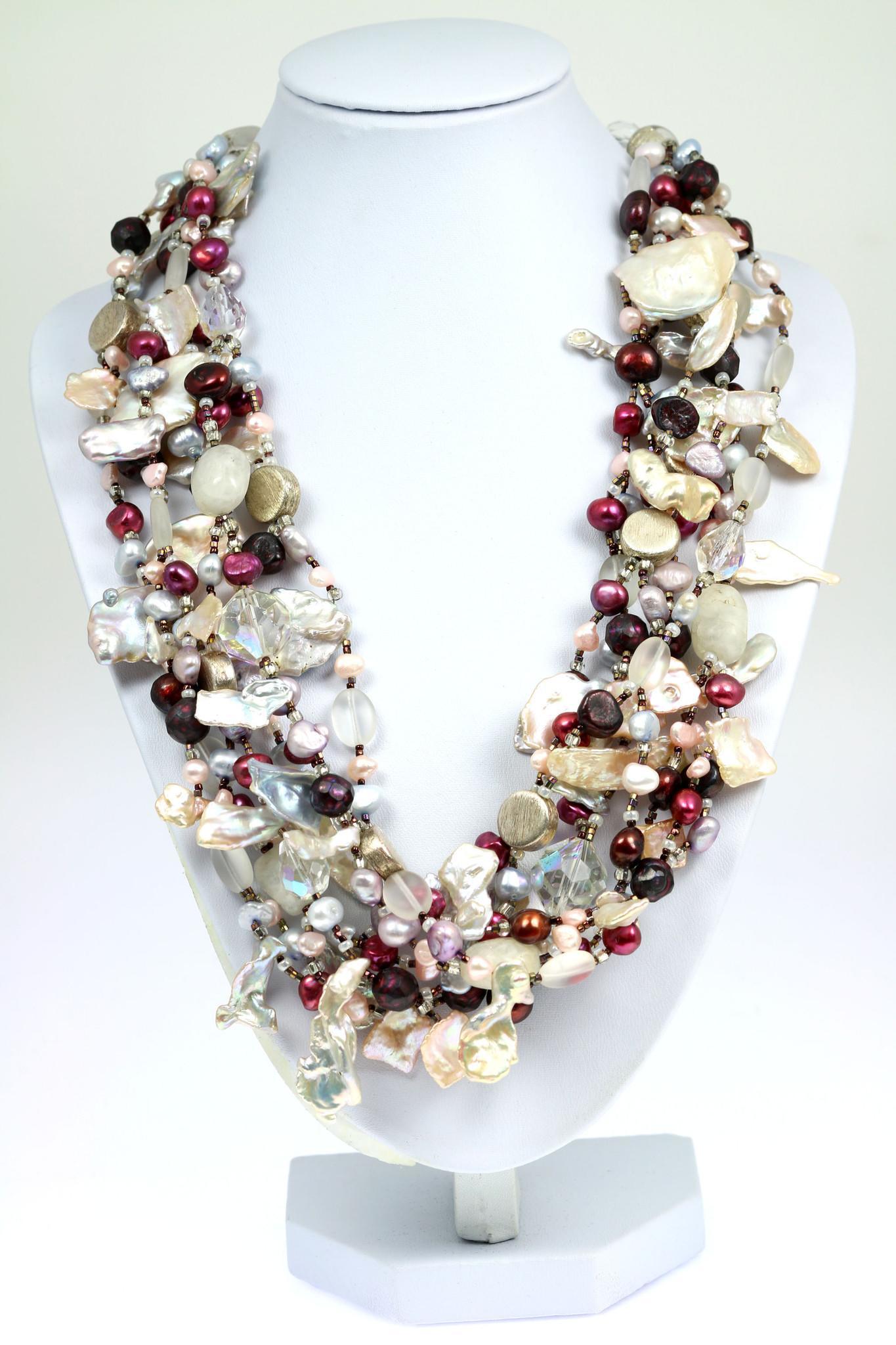 A Keishi Cornflake Pearl Beaded Gemstone Necklace on a White Neck Display