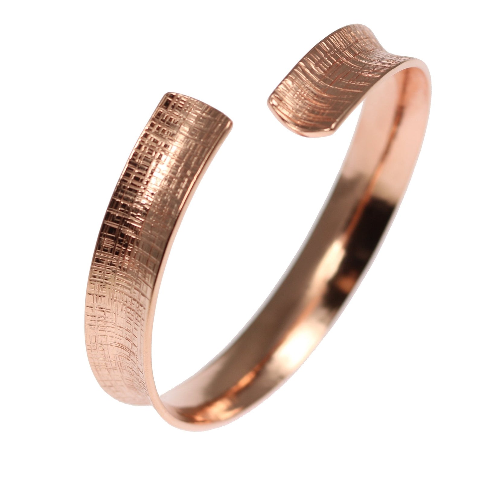A Linen Anticlastic Copper Bangle Bracelet on a White Background