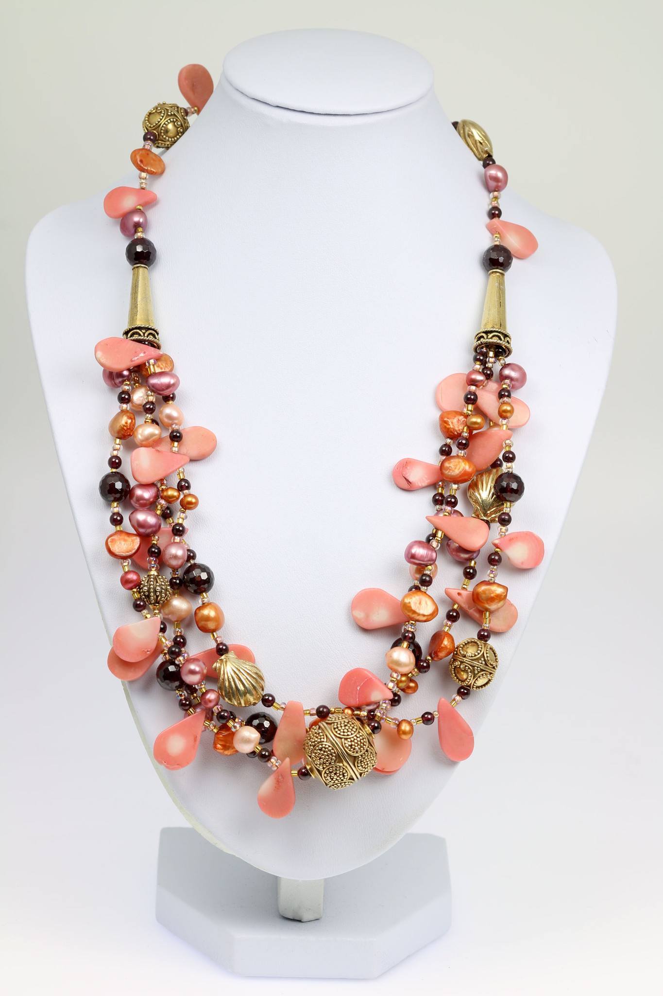A Pink Coral Garnet Beaded Gemstone Necklace on a White Neck Display