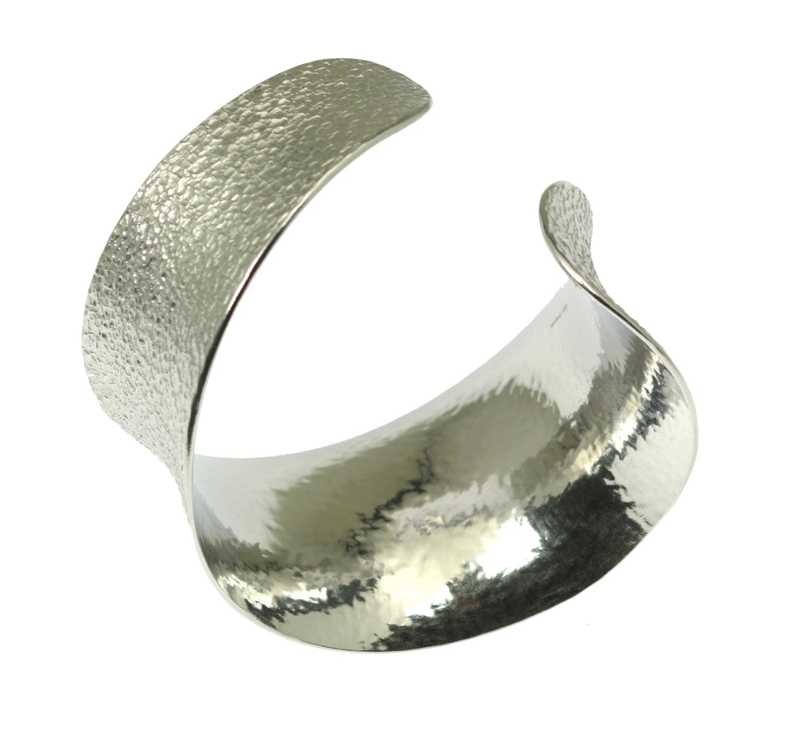 A Texturized Aluminum Anticlastic Bangle on a White Background