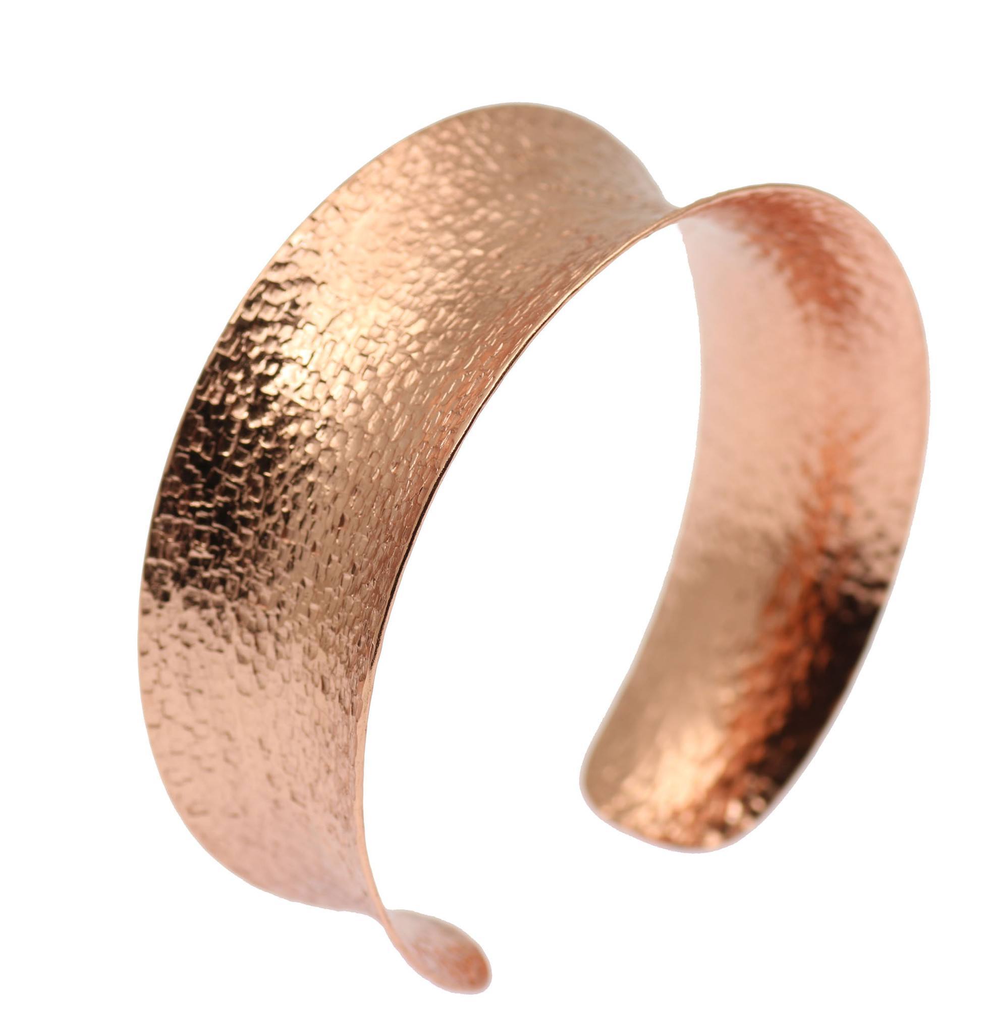 1 of 7: A Texturized Copper Bangle Bracelet on a White Background