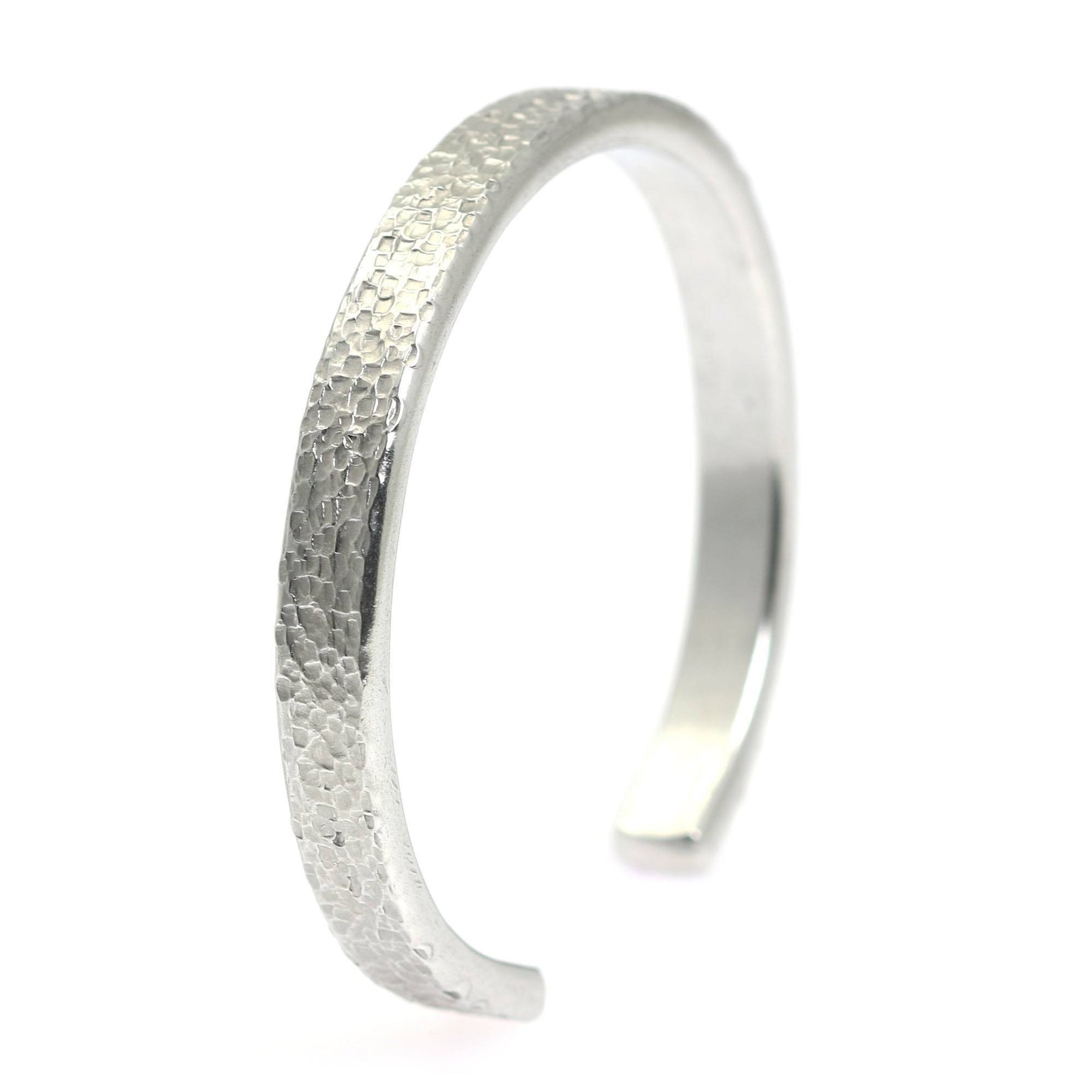 A Thin Texturized Aluminum Cuff Bracelet on a White Background