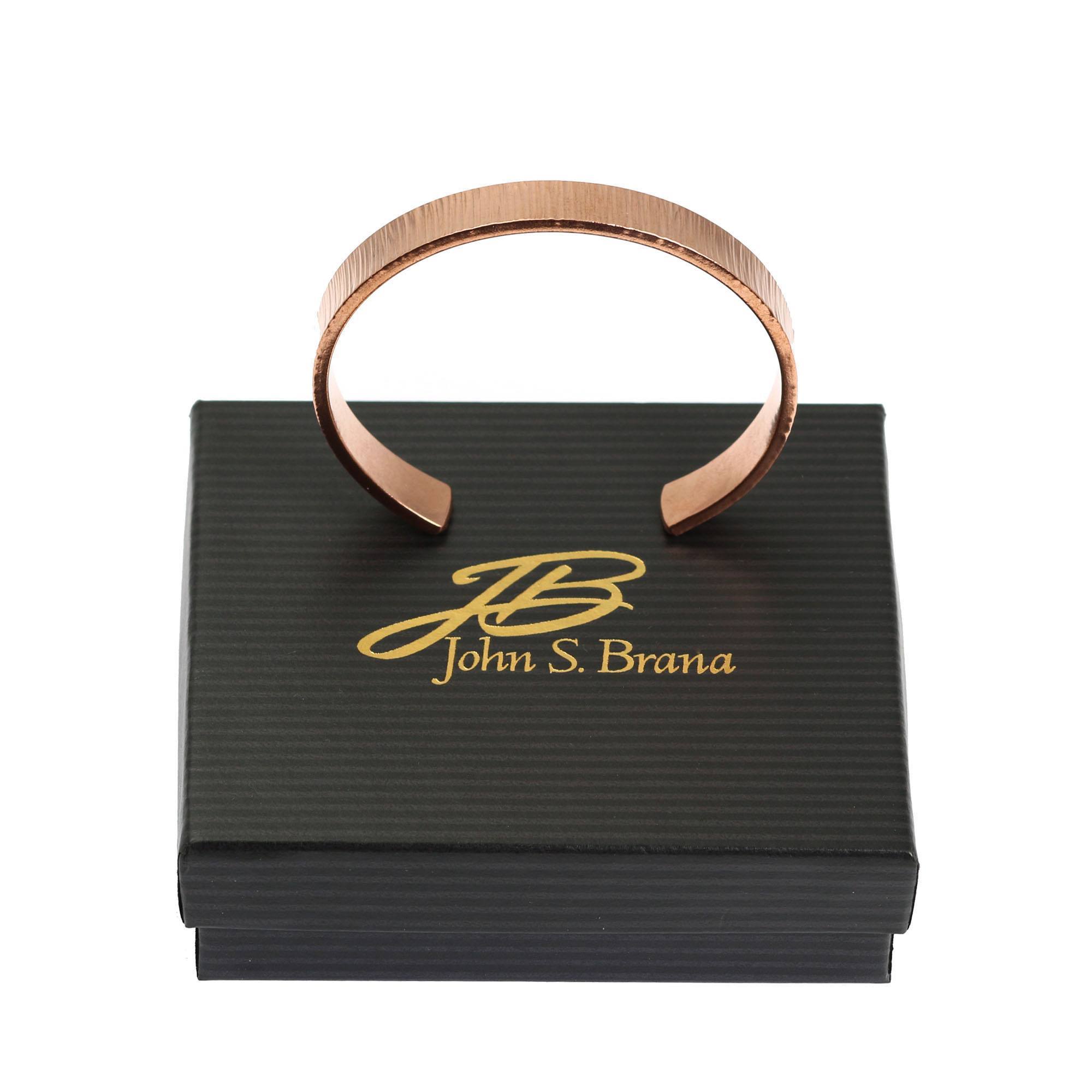 10mm Wide Chased Copper Cuff Bracelet on top of a Black Gift Box