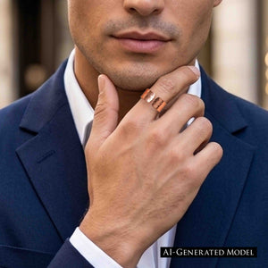 2 of 9: Close up of a man wearing a wide hammered copper cuff ring on his finger, with a polished finish that reflects light. His hand rests thoughtfully against his chin, showing the ring’s open cuff design. He is dressed in a navy suit jacket and white shirt, giving the ring a clean, modern, and slightly dressy look.  AI Generated Model.
