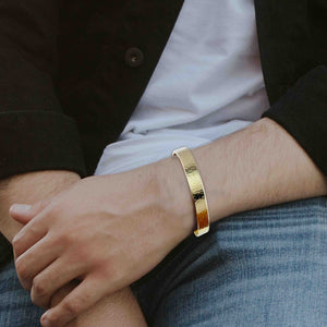 7 of 9: 10mm Hammered Nu Gold Brass Cuff Bracelet  on a man's wrist with a blurred background