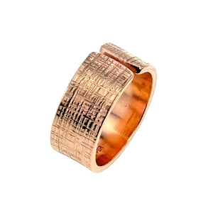 3 of 8: A handcrafted 10mm wide copper cuff ring with a linen-textured finish and an open-front design. The ring showcases a warm, reddish copper tone with detailed crosshatch patterns across the surface, giving it a rugged yet refined appearance.