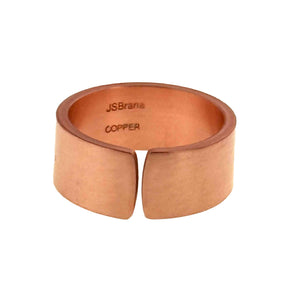 5 of 9: Front view of a matte copper cuff ring with a wide 10mm band and open adjustable gap, featuring a smooth hand polished finish and warm reddish tone, with “JSBrana” and “Copper” stamped inside, displayed on a clean white background.
