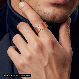 4 of 9: Close-up of a hand wearing a matte copper cuff ring with a wide open band and brushed finish, styled on the finger near a man’s face with light stubble, creating a modern, minimal look against a dark background.  AI Generated Model.