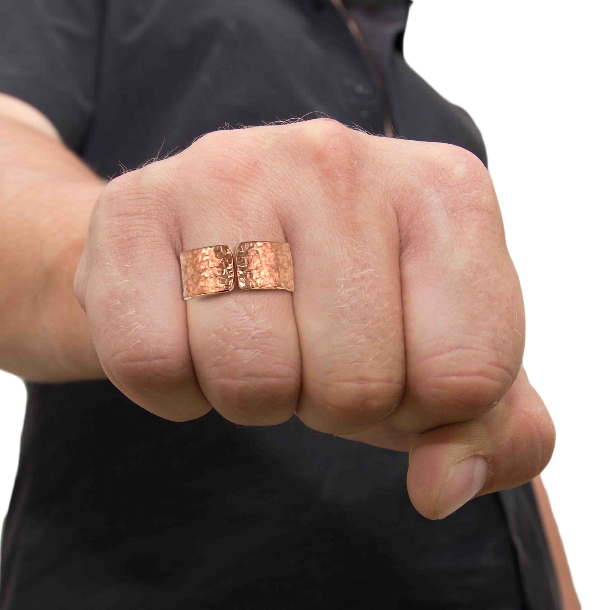 Hand wearing 10mm Texturized Copper Cuff Ring on a blurred background