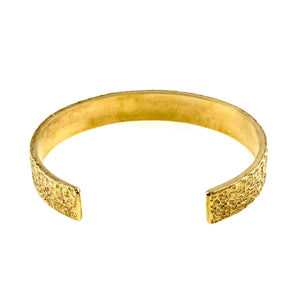 5 of 9: Front view of a wide textured Nu Gold brass cuff bracelet with an open-back design, highlighting the hammered surface and clean, minimalist shape.