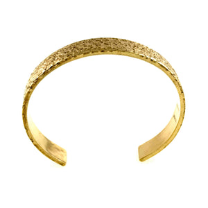 7 of 9: Top view of a wide textured Nu Gold brass cuff bracelet, showing the curved open-back shape, hammered surface detail, and warm golden finish.