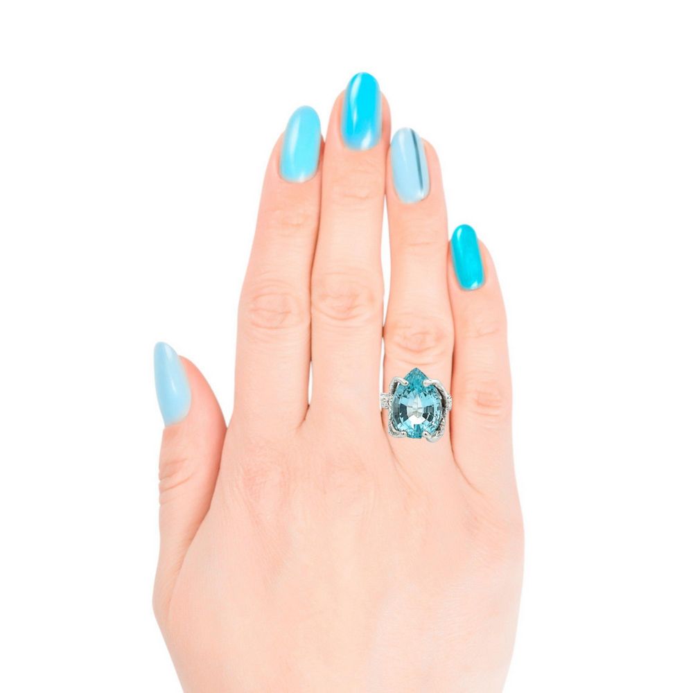 Swiss Blue Topaz Sterling Silver Cocktail Ring Female Hand with Blue Fingernail Polish