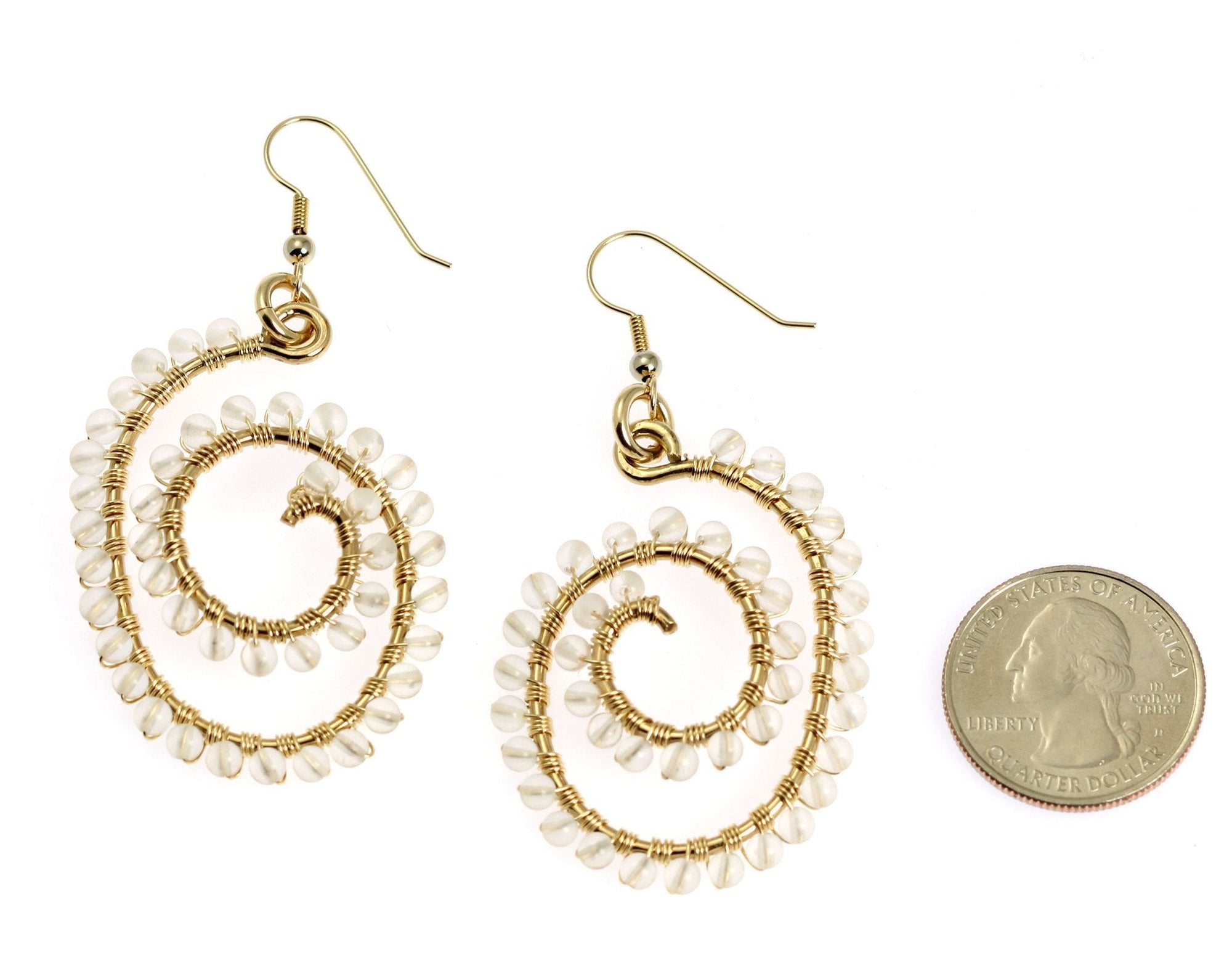 Wire Wrapped Spiral Earrings With Crystal Quartz Gemstones compared to a US Quarter Coin for Size Dimensions