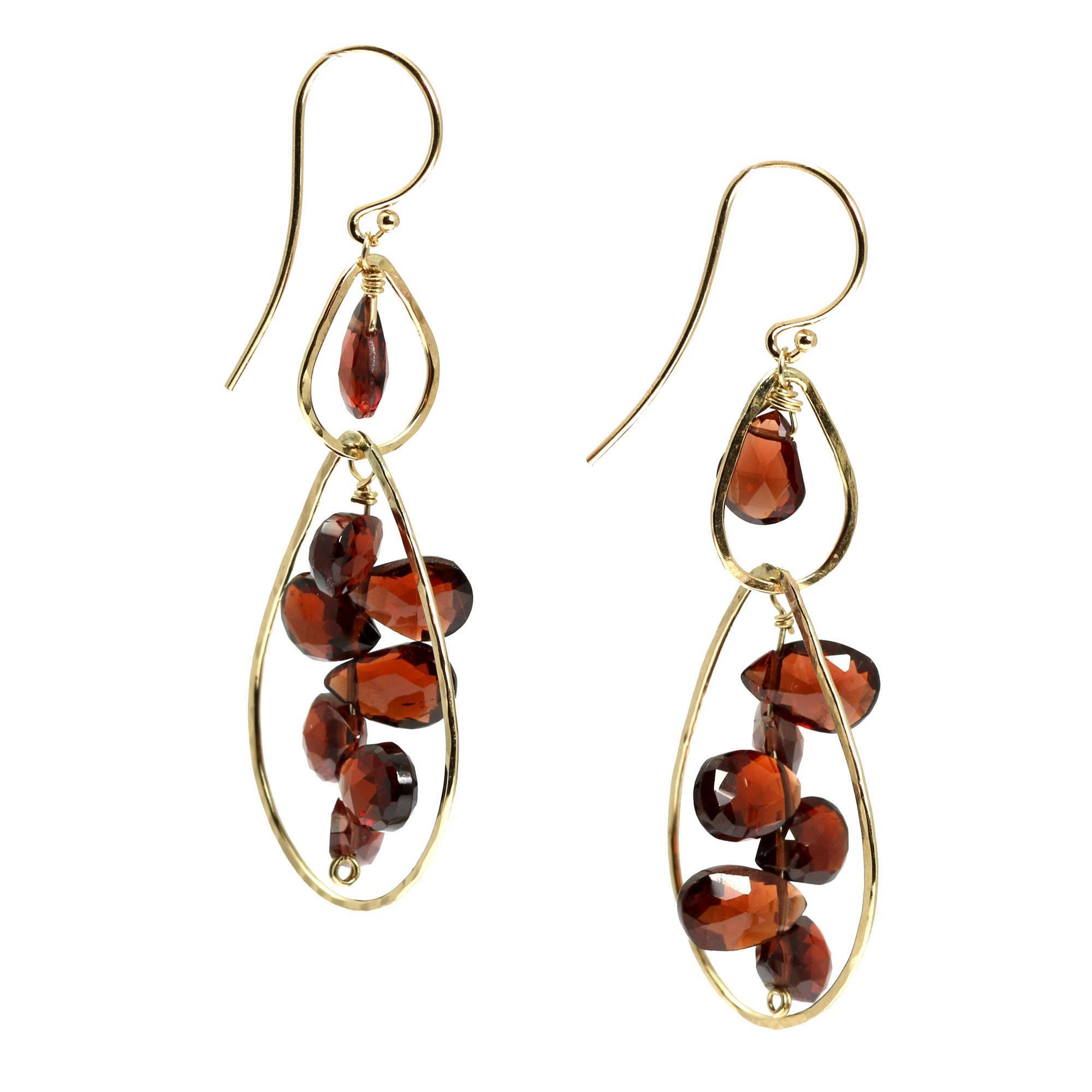 Close Up of 14K Gold Hammered Earrings With Garnets