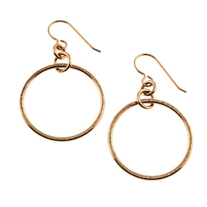 1 of 8: Pair of 1 Inch Chased Bronze Hoop Earrings shown from the front and back on a clean white background. Each earring has a round bronze hoop, hand chased edge texture, polished surface, connecting rings, and a bronze French ear wire.