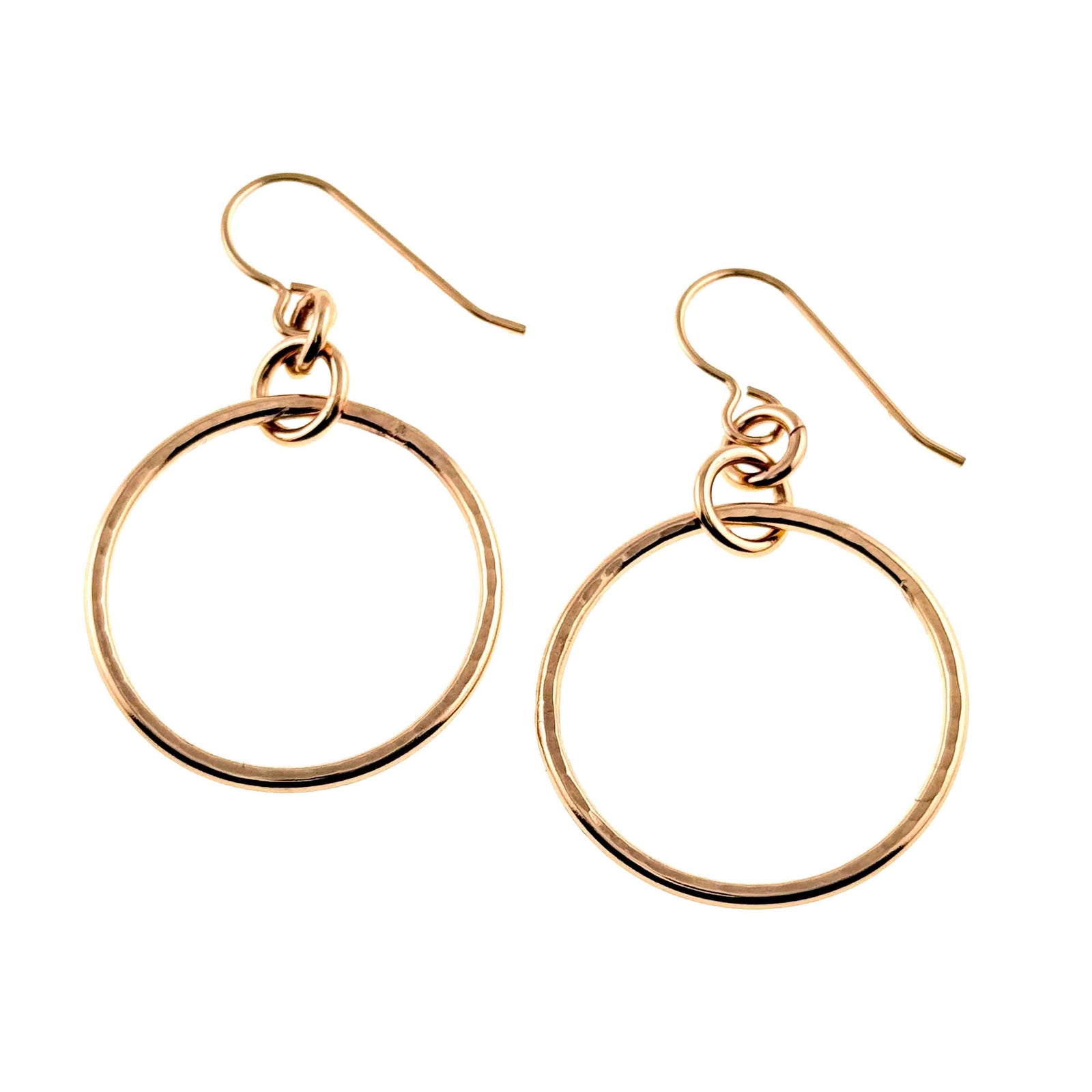 Pair of 1 inch hammered bronze hoop earrings displayed on a clean white background. The round bronze hoops have a glossy polished finish with subtle hand hammered texture and hang from bronze French ear wires through small connecting rings.