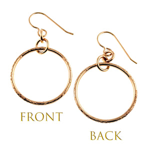 5 of 8: Front and back views of the 1 Inch Texturized Rim Bronze Hoop Earrings on a white background. The round bronze hoops feature hand textured rims, polished surfaces, connecting rings, and bronze French ear wires. Gold text labels the front and back views.
