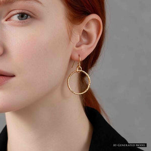 7 of 8: AI generated model with red hair pulled back, shown wearing a 1 Inch Texturized Rim Bronze Hoop Earring. The polished bronze hoop hangs from a French ear wire beside the jawline, showing its one inch size and warm color against a black top and gray background.
