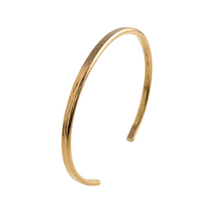 3 of 9: A handcrafted 3.5mm wide solid bronze cuff bracelet with a subtle bark-textured surface. The bracelet features a warm golden-bronze tone and a gently curved open design, making it easy to slip on and off the wrist. Its slim profile and organic texture give it a natural, earthy elegance perfect for everyday wear or meaningful gifting.