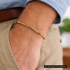 6 of 9: A close-up of a man's wrist wearing a 3.5mm bark-textured bronze cuff bracelet with a warm golden tone. The bracelet has a slim, open design and a natural, handcrafted finish. He is dressed casually in a light blue shirt and beige pants with a brown belt, showcasing the bracelet's understated and masculine style suitable for everyday wear.  AI Generated Model.