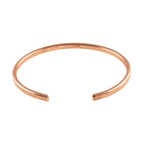 6 of 10: A close-up image of a handcrafted 3.5mm wide copper cuff bracelet with an open-ended design, photographed against a white background. The bracelet is made from solid, raw copper and features a lightly embossed bark texture along its outer surface, adding a subtle organic detail. The polished reddish tone of the copper gives it a warm, natural glow. The inner band is smooth, with a faint engraved stamp indicating the metal type. The open ends are softly rounded for comfort and adjustability, emphasizing the 