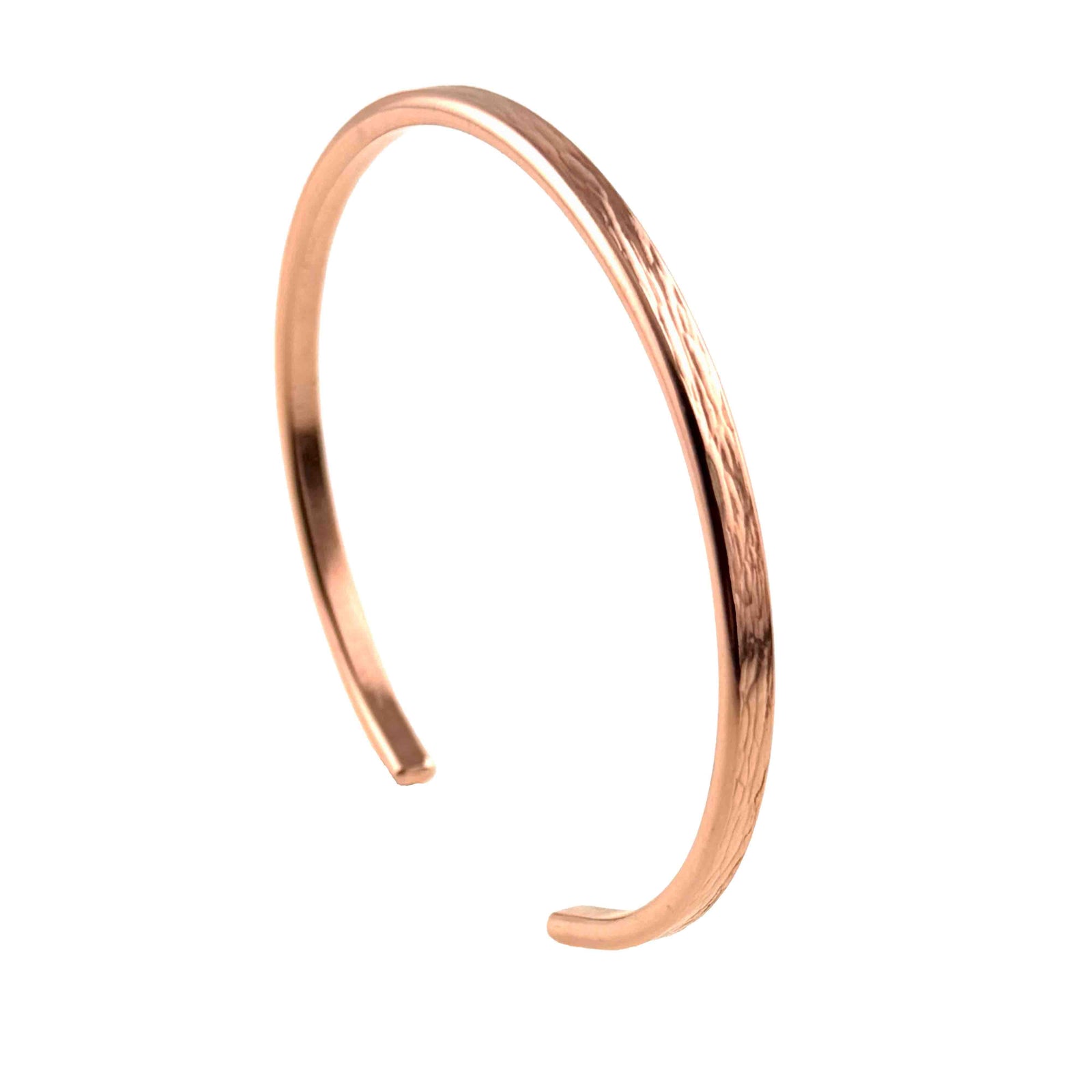 A handcrafted 3.5mm wide copper cuff bracelet with a subtle bark-textured surface. The bracelet is made from raw, non-oxidized copper and features a minimalist open-ended design for easy wear. Its sleek, slightly curved shape and natural reddish tone reflect its artisanal quality, highlighting the light-engraved bark pattern that adds organic character to the otherwise smooth finish. The bracelet is photographed against a plain white background, emphasizing its warm metallic hue and clean lines.