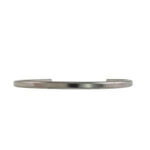 3 of 10: Front view of a slim 3.5mm brushed stainless steel cuff bracelet against a white background. The narrow silver tone bracelet has a smooth matte finish, a gently curved shape, and open ends visible behind the front band.