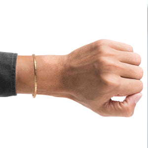 2 of 9: A Man wrist wearing a 3.5mm Chased Bronze Cuff Bracelet  on a white background