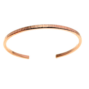 7 of 11: A minimalist 3.5mm wide raw copper cuff bracelet featuring a subtle hand-chased texture, displayed on a white background with an open-ended design for easy wearing.