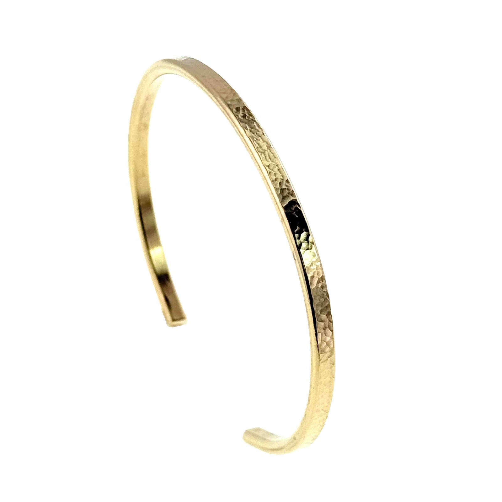 Slim hammered Nu Gold brass cuff bracelet with a warm golden tone and narrow 3.5mm width. Open cuff design with gently rounded ends and a lightly textured surface that reflects light. Minimalist, handcrafted style shown against a clean white background, perfect for everyday wear or stacking.