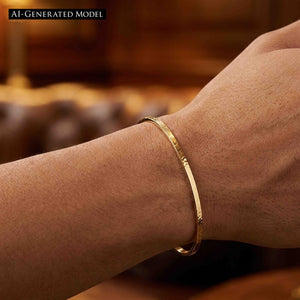 4 of 10: Close-up of a slim hammered Nu Gold brass cuff bracelet worn on a wrist, highlighting its narrow 3.5mm width and softly textured surface. The open cuff sits just above the wrist bone, reflecting warm golden tones against the skin. The background is softly blurred with warm brown hues, giving a cozy, lifestyle feel that emphasizes the bracelet’s simple, handcrafted style.  AI Generated Model.